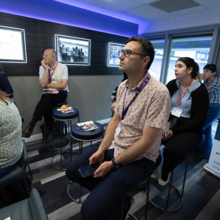 Small group session with people seated, attentively listening to a speaker.